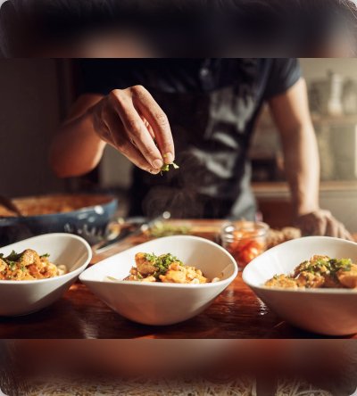 A person is eating food from bowls on the table.